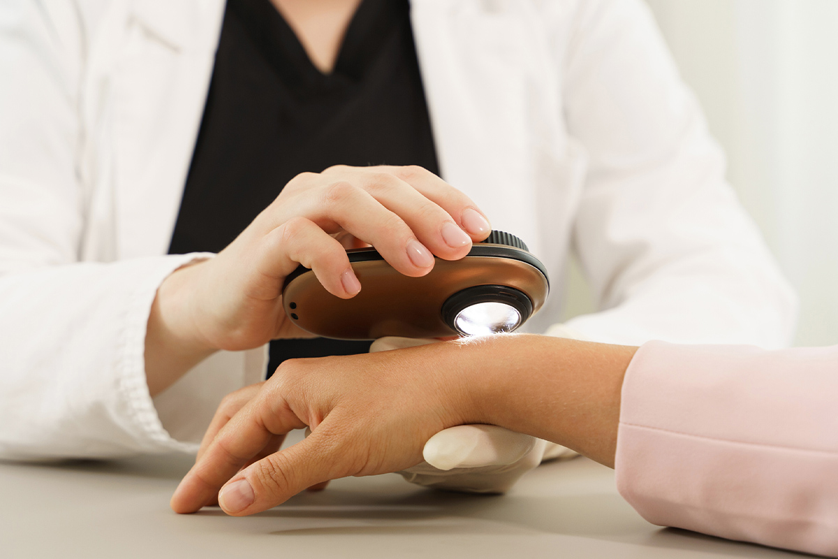 a dermatology specialist examining a patient's arm